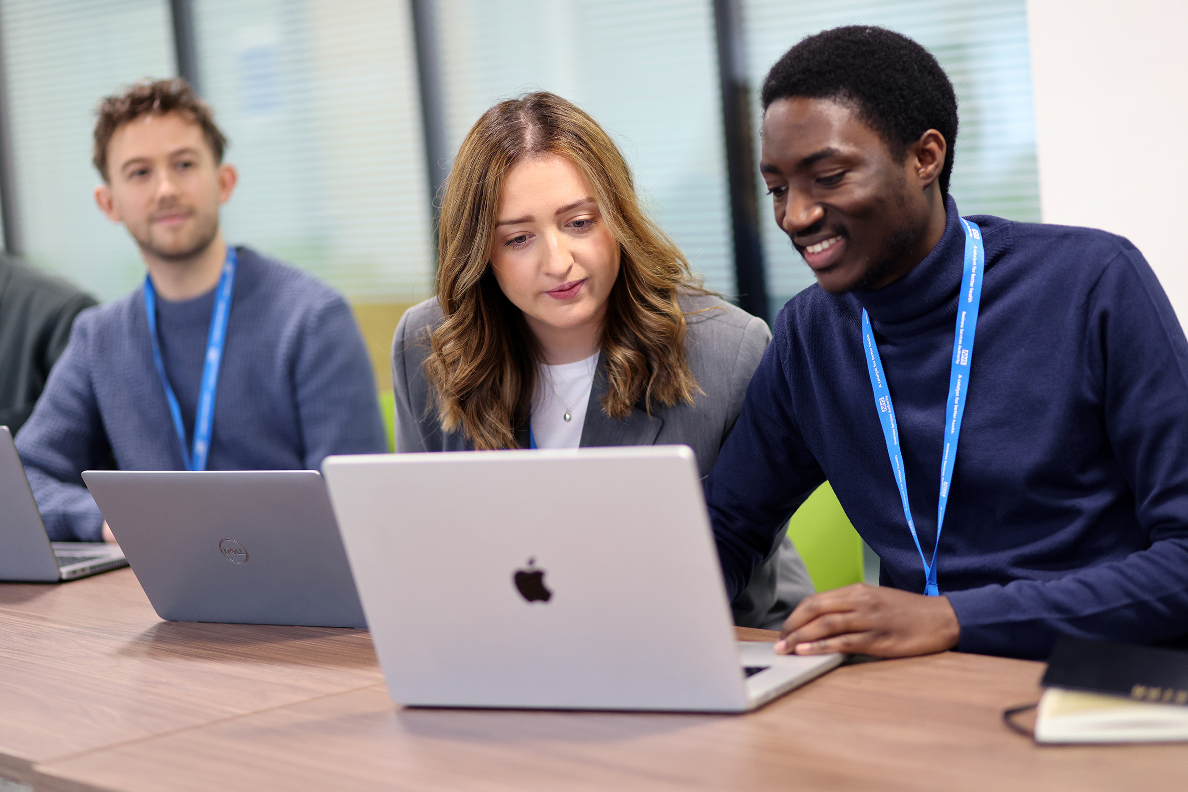 People looking at a laptop screen